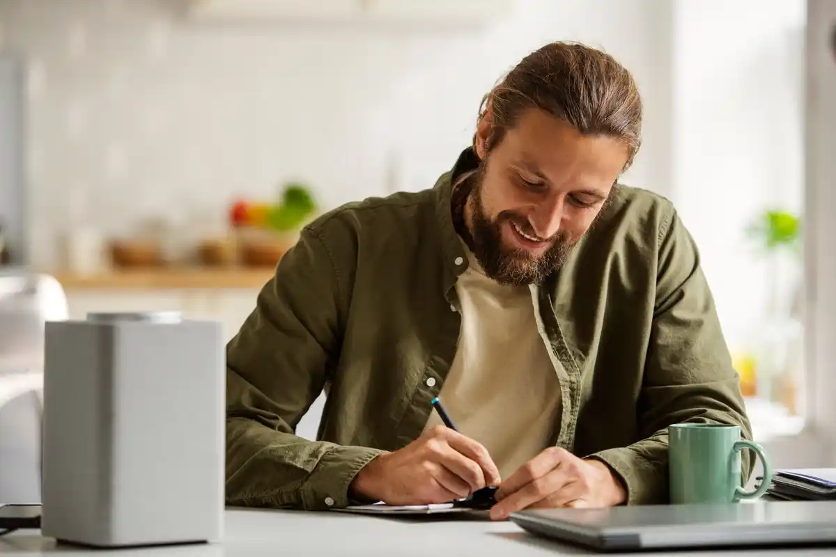 man making daily task plan at desk
