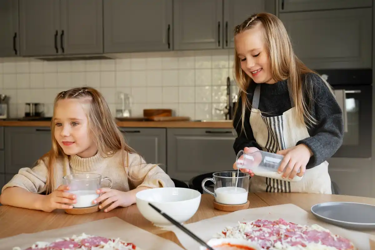 family enjoying cooking together in kitchen at home
