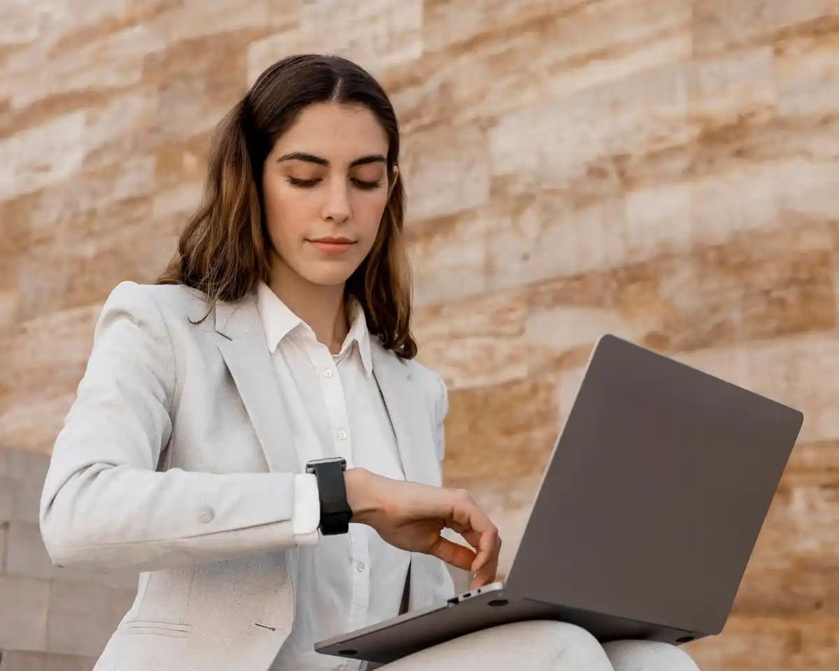 Person focused working with timer and laptop
