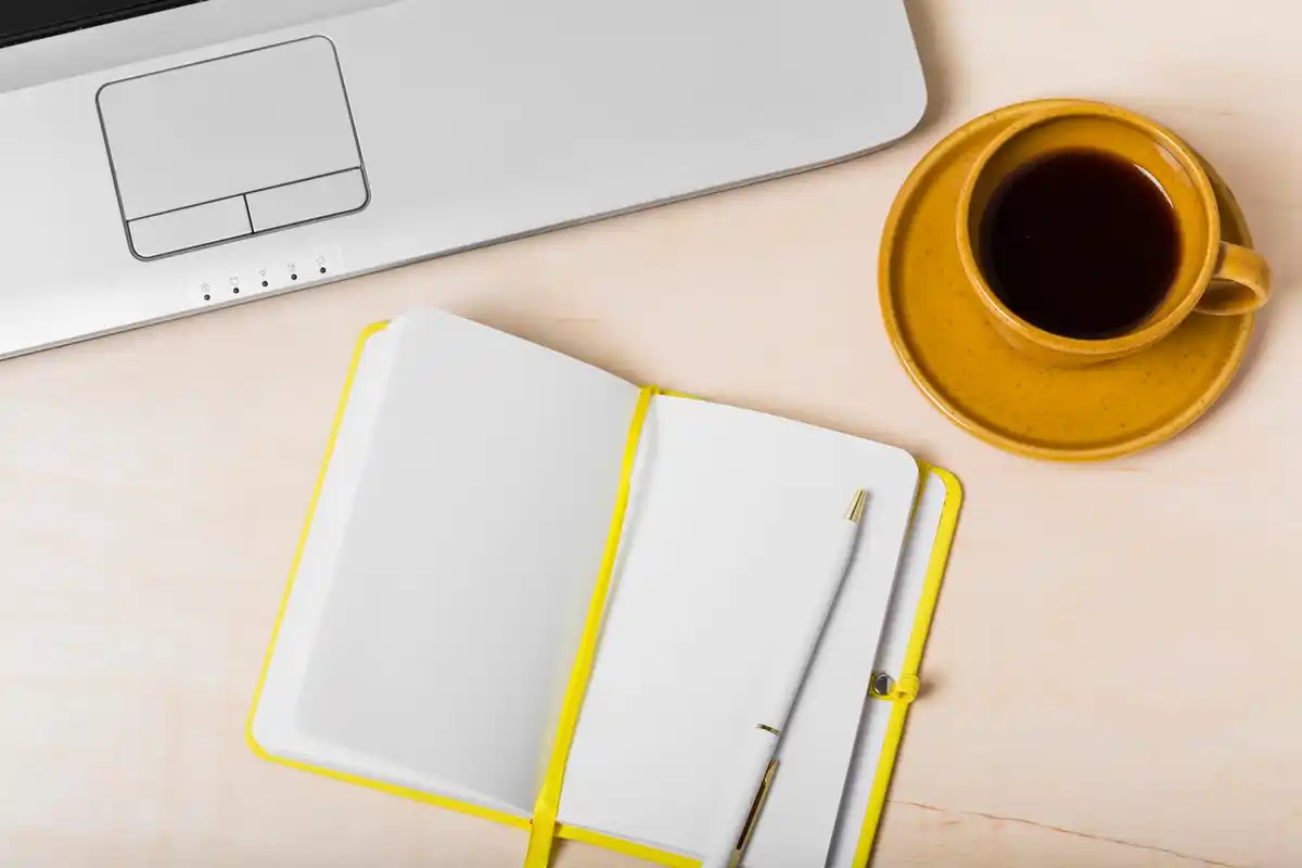 organized task management workspace laptop planner coffee