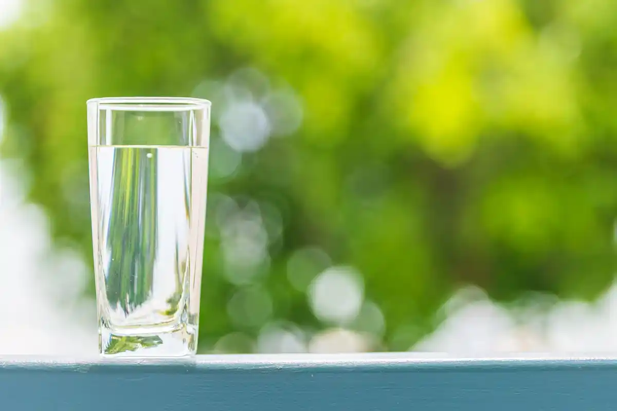 Refreshing glass of water on wooden table