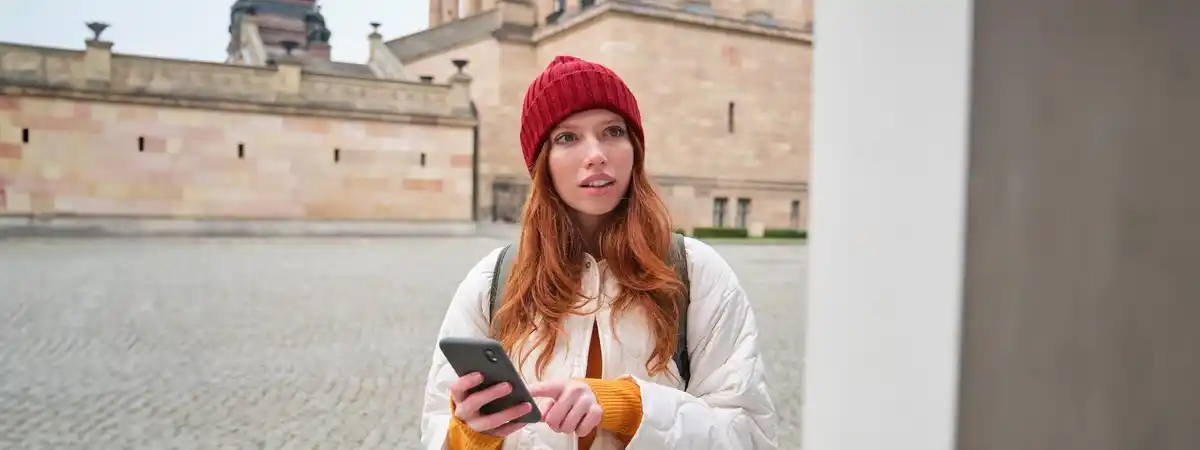person using smartphone with tips Dutch city