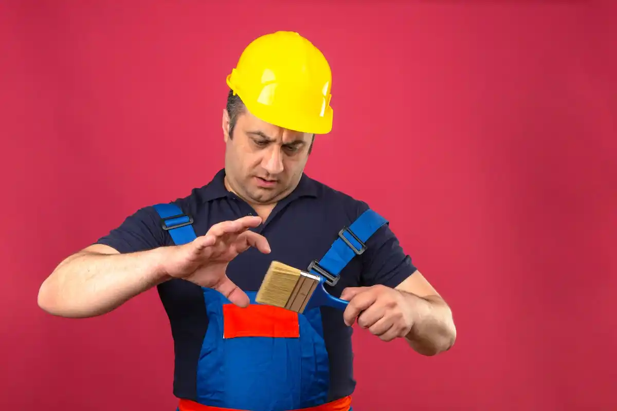 dutch handyman using magnetic tape measure and glue