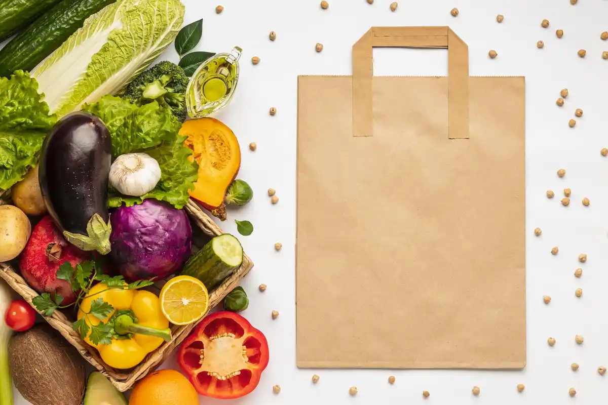fresh cucumber and bell pepper in paper bag