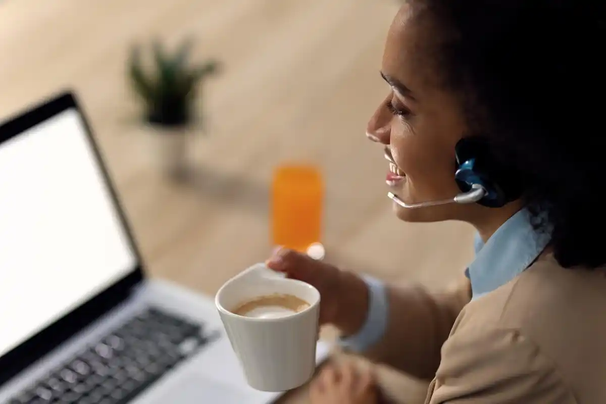focused person working desk headphones coffee