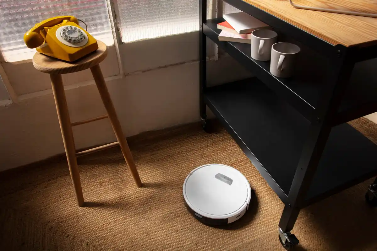 robot vacuum cleaner cleaning living room floor