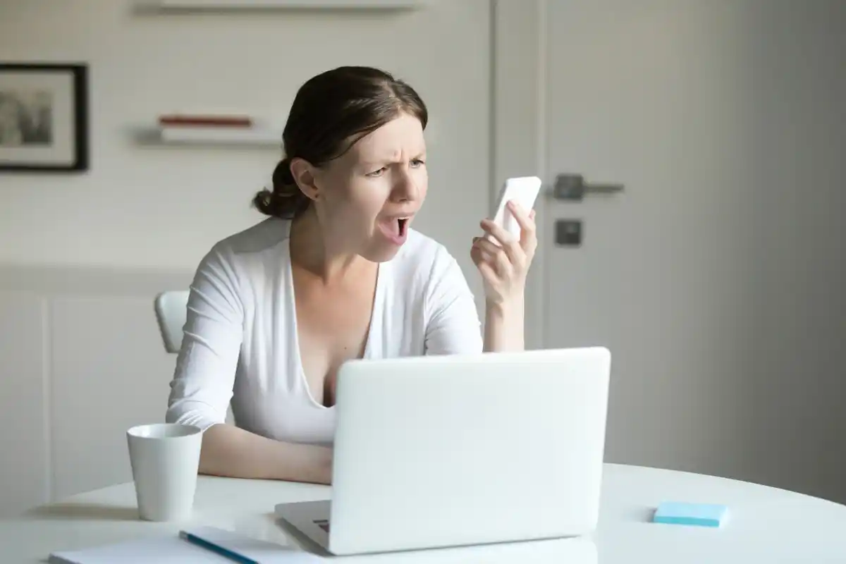 frustrated person fixing slow laptop wifi smartphone notifications