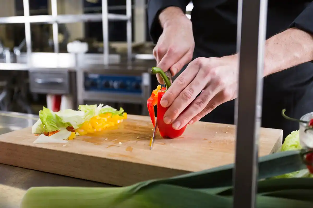chef slicing vegetables with sharp knife
