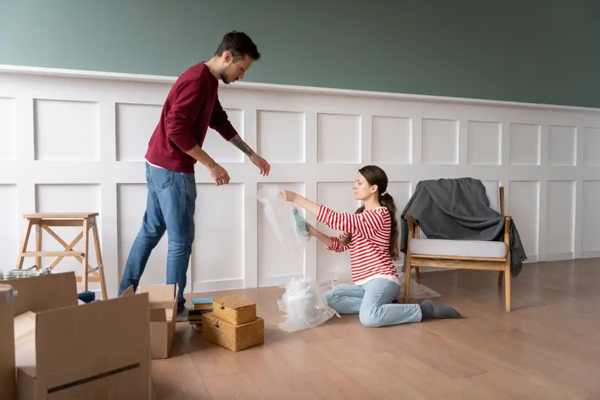 family tidying up living room together