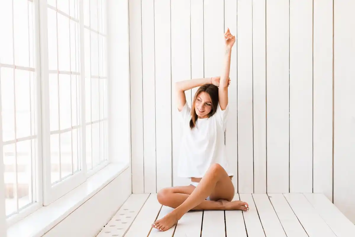 energetic morning person stretching sunlight window