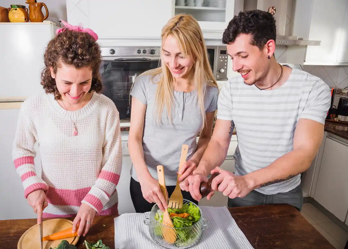 friends cooking together on vacation kitchen happy group