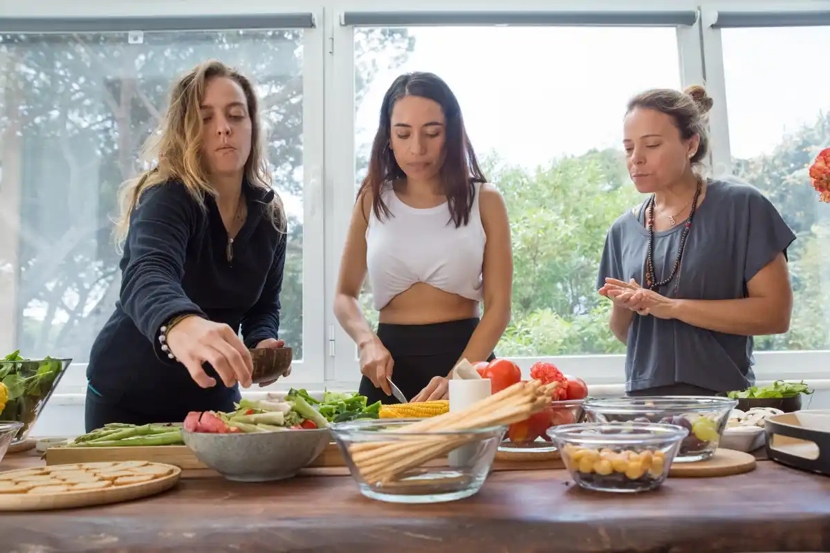 friends cooking together in vacation rental kitchen