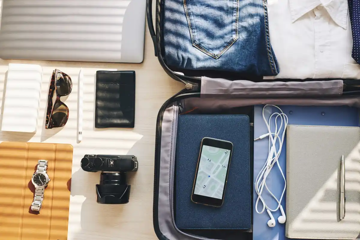 compact powerbank and smartphone on travel bag