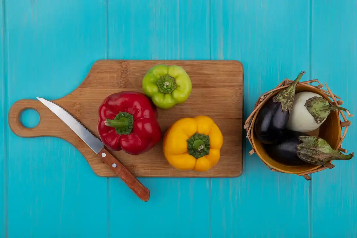 sharp kitchen knife on cutting board vegetables