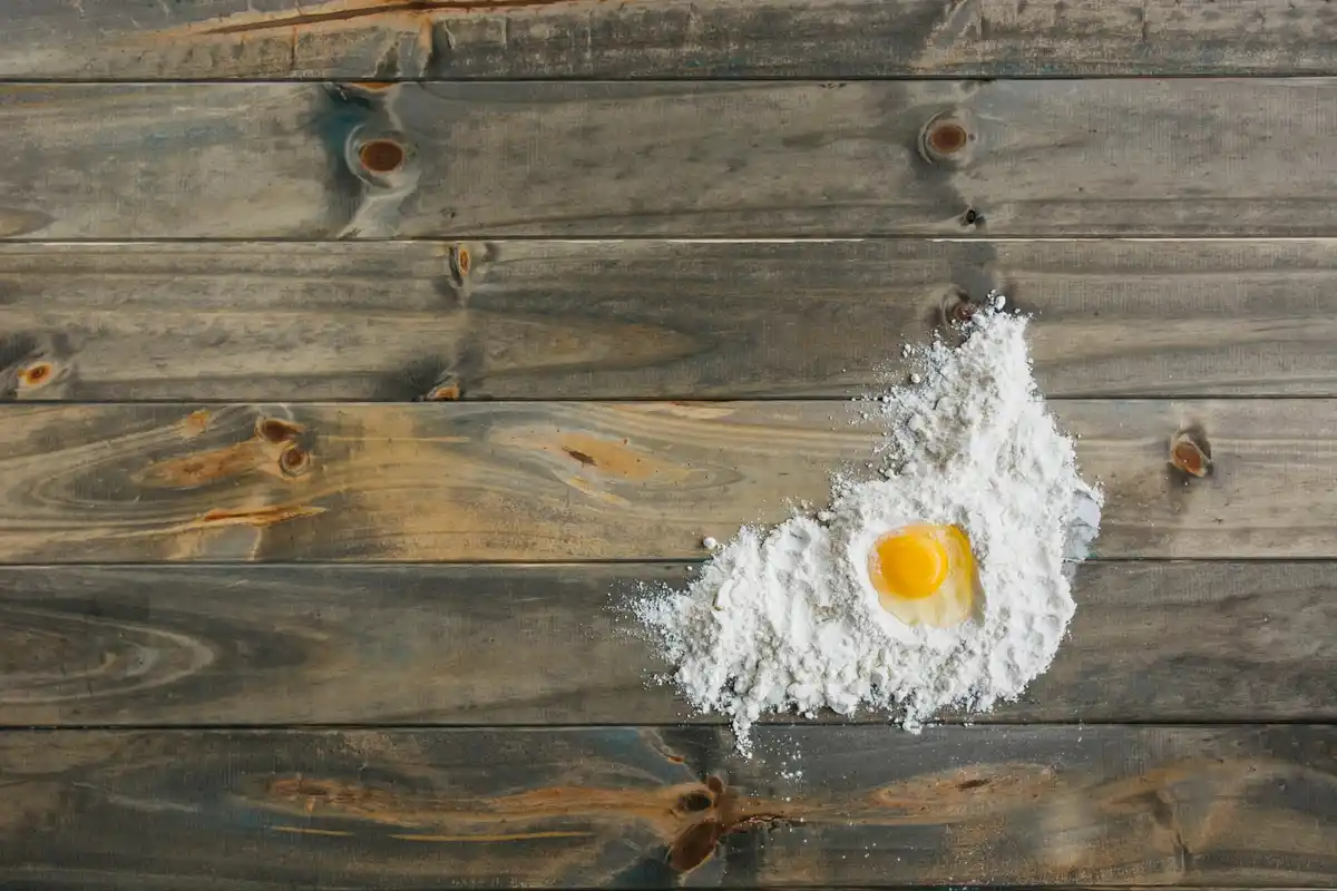 fresh homemade pasta on wooden table with flour