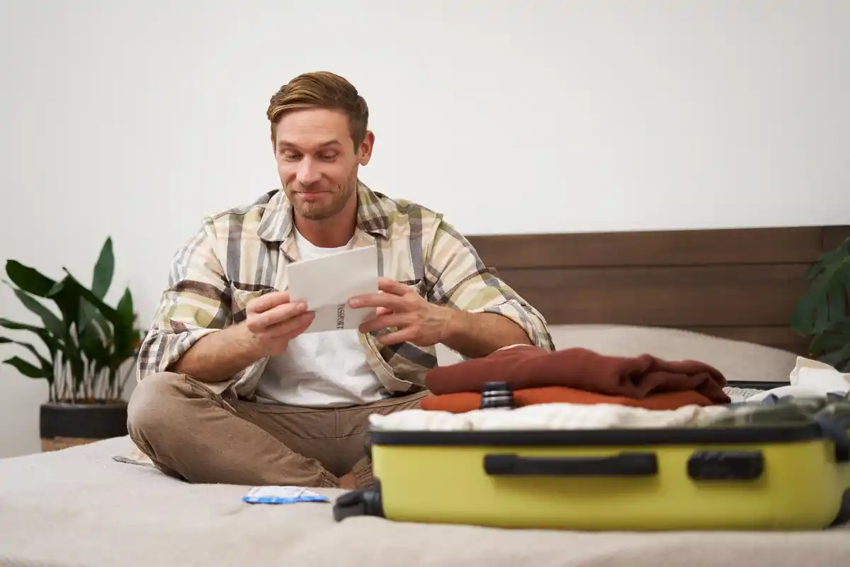 person packing suitcase with checklist