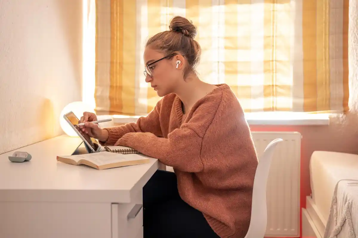 focused person working with planner and coffee