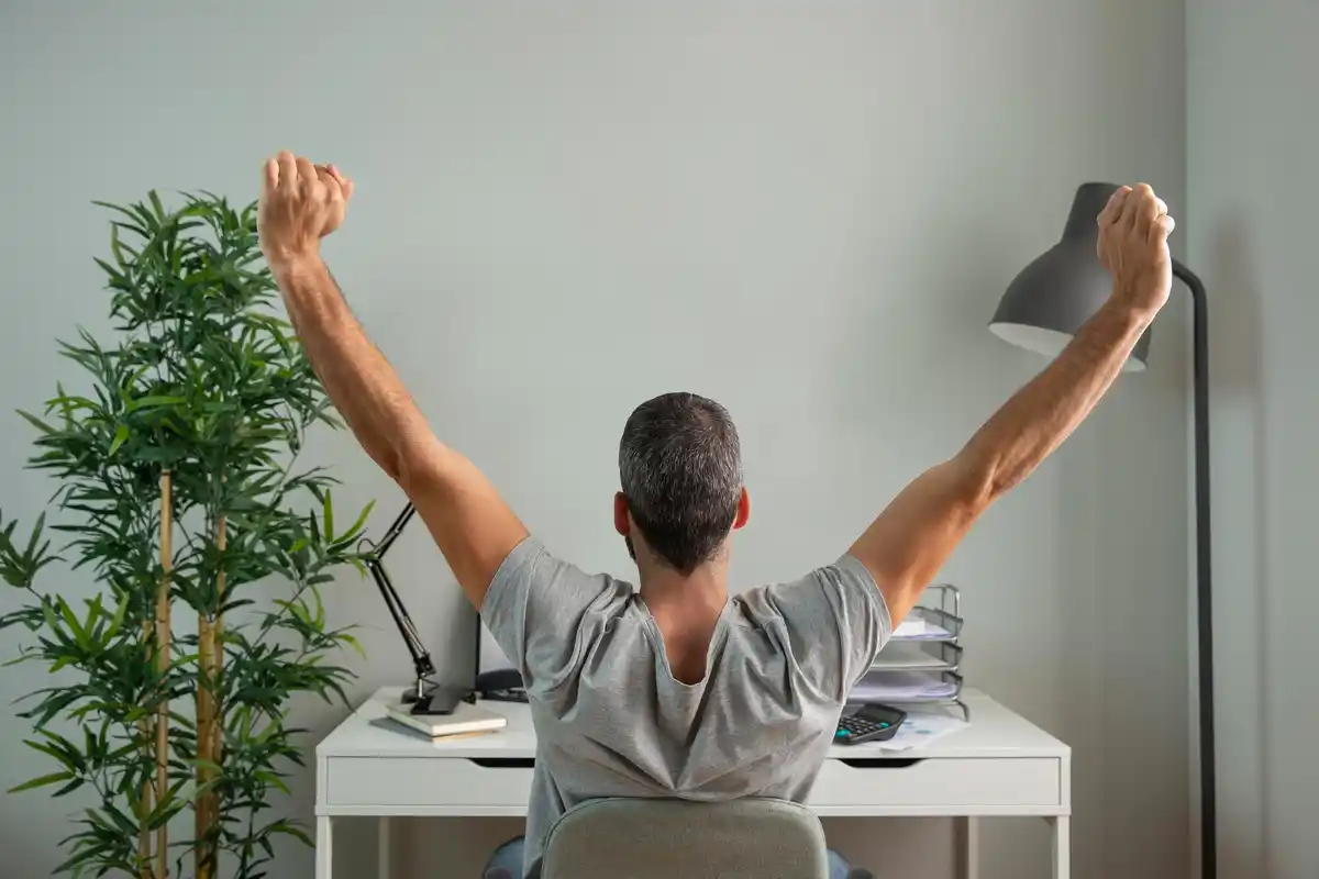 person stretching at work energy boost