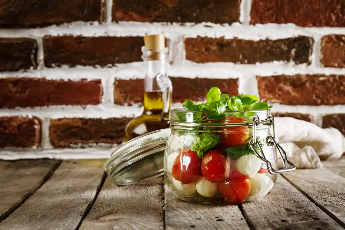 fresh herbs in glass jar fridge kitchen