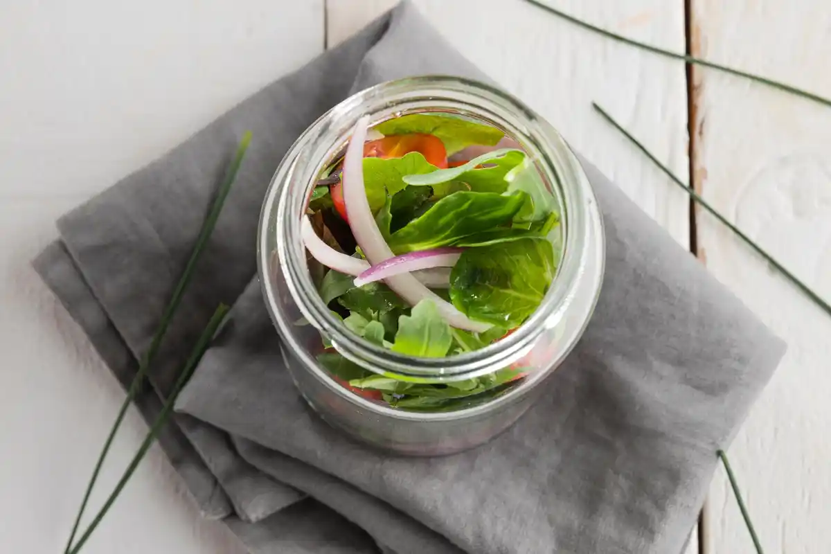 fresh herbs in glass jar fridge