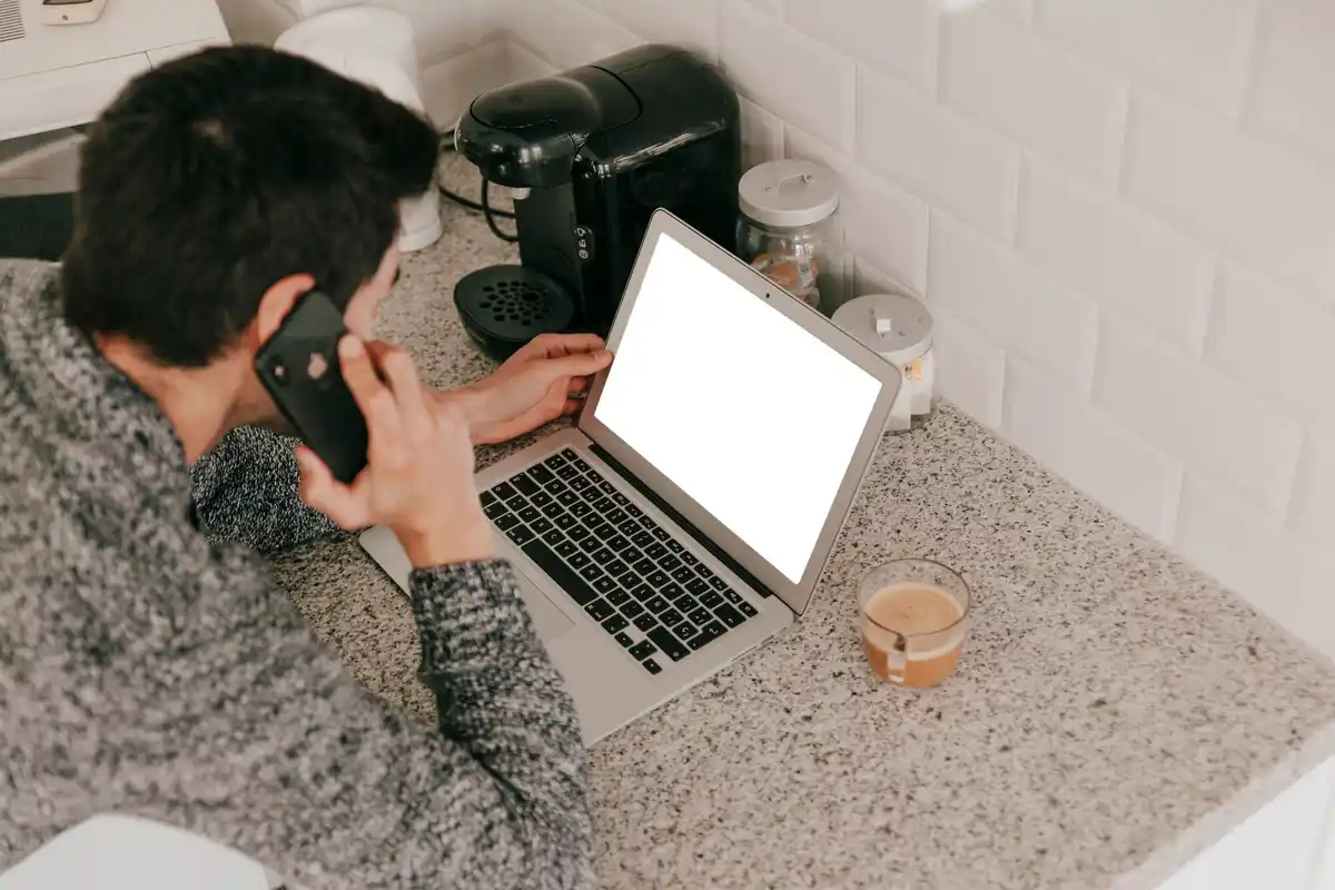 laptop user optimizing settings at home desk