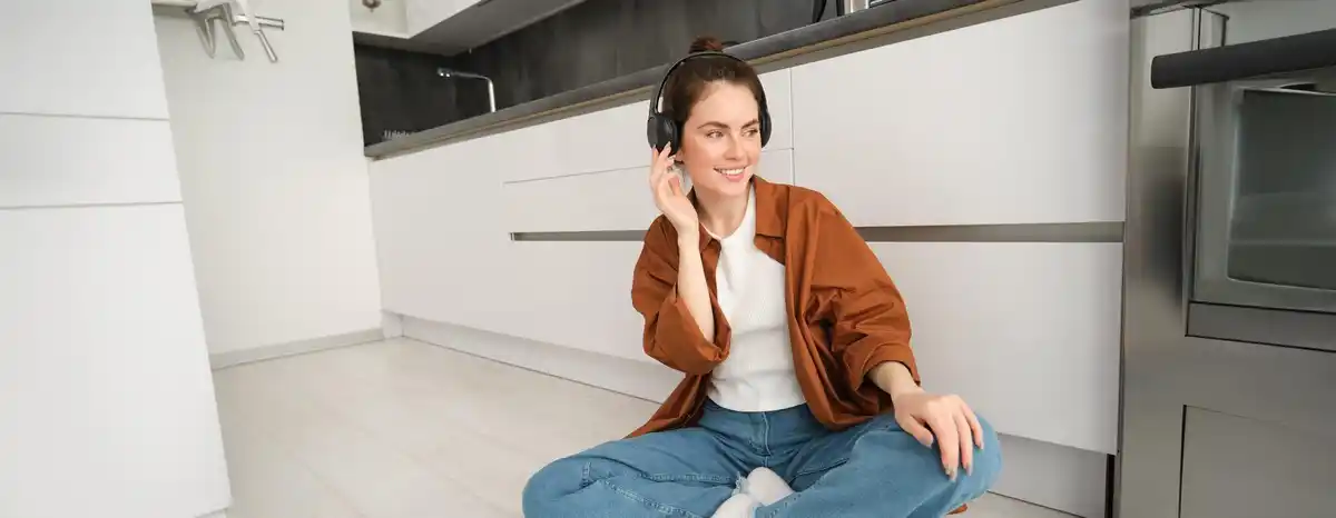 person wearing noise cancelling headphones at home