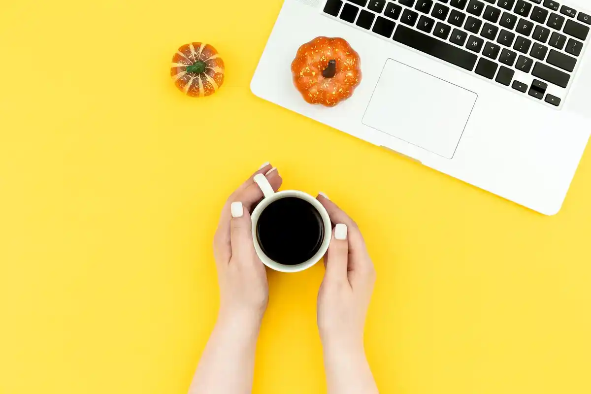 busy work desk with laptop and coffee