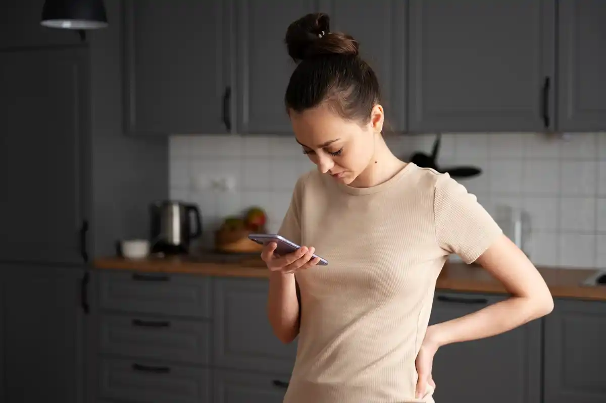 person checking to-do list on smartphone at home