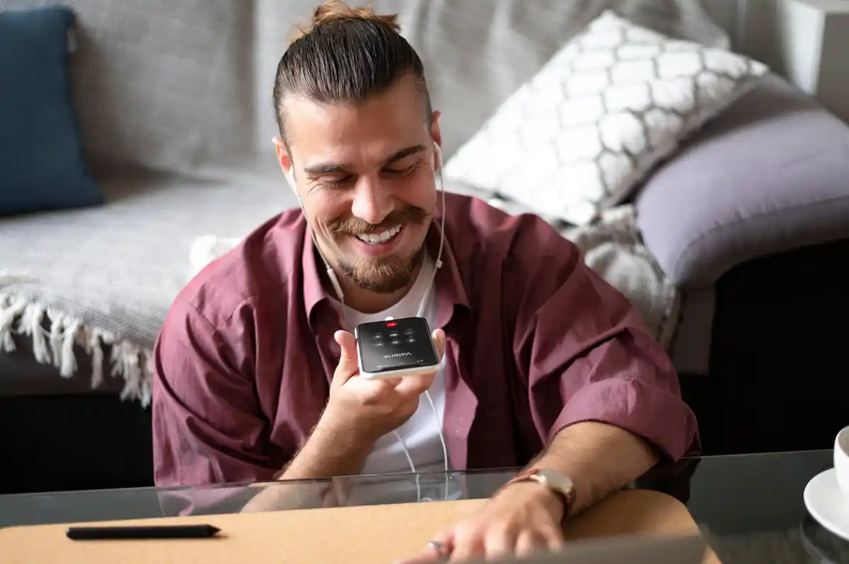 person setting timer on phone at home workspace