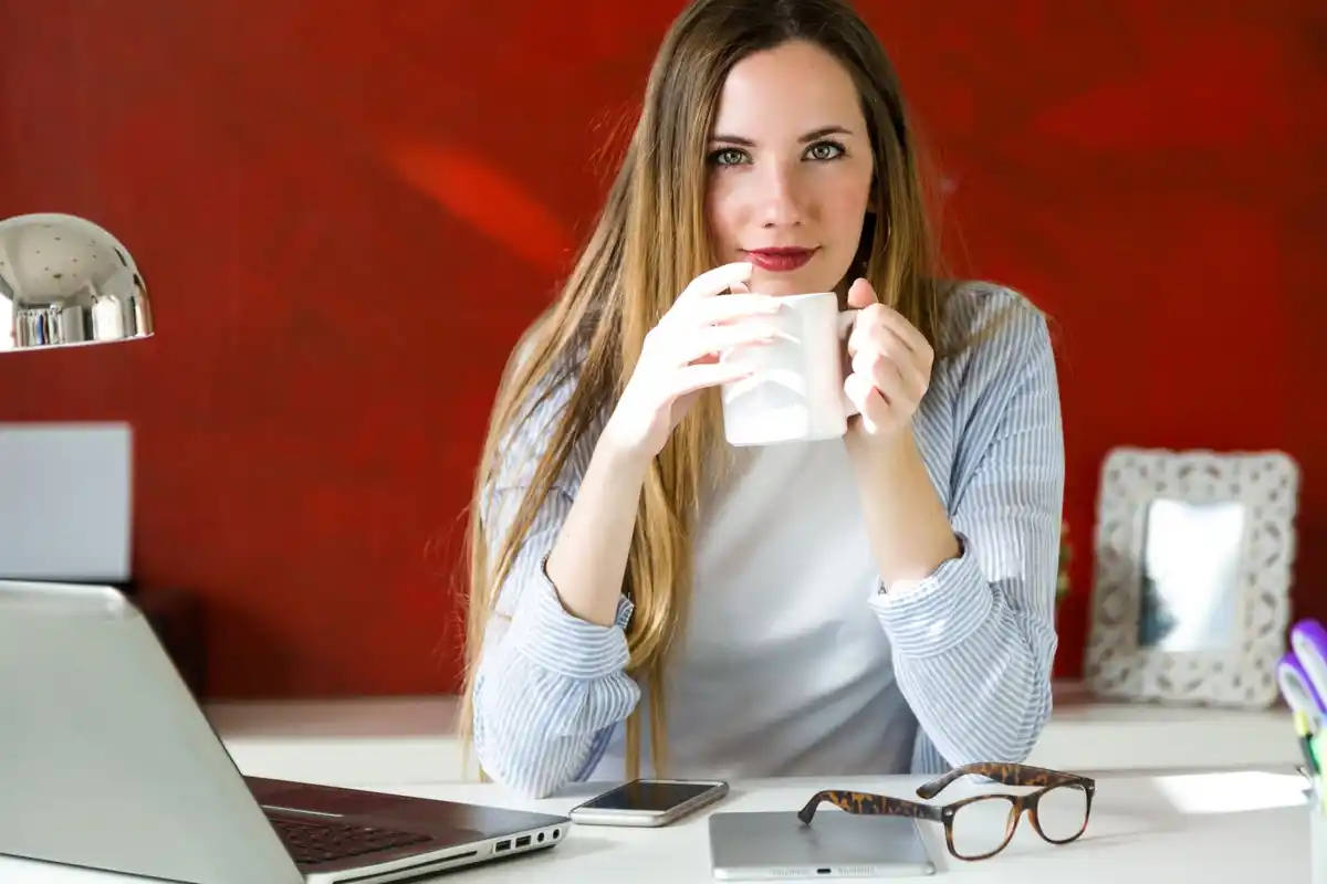 young woman taking a coffee break at modern office