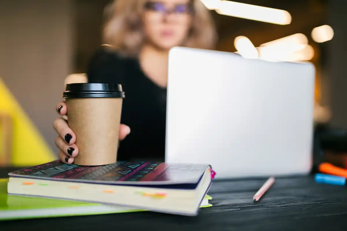 working efficiently at desk with laptop and coffee