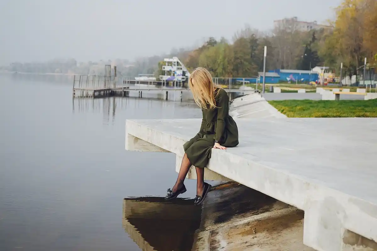 person enjoying a leisurely walk in a Dutch canal-side park