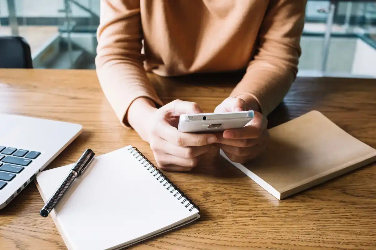 person delegating tasks using smartphone