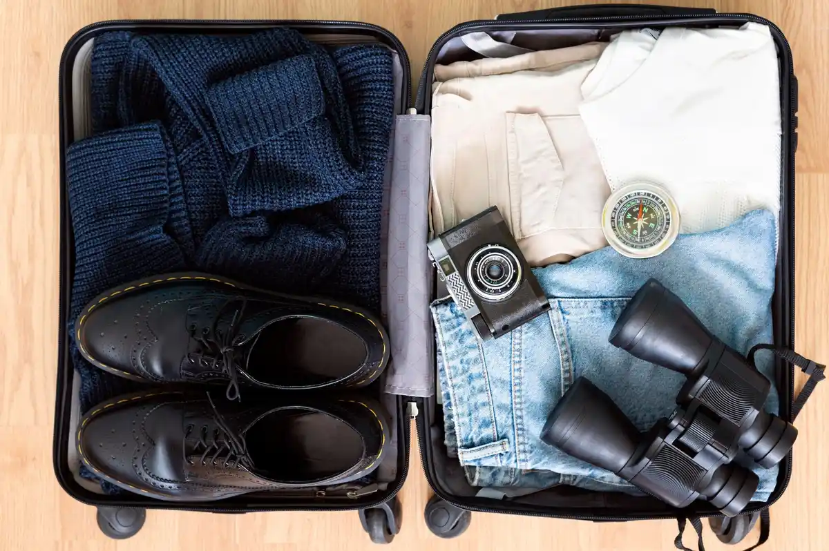 neatly packed suitcase with folded clothes