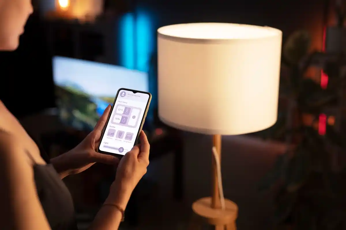 person controlling smart plug with phone