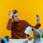 frustrated person with smartphone troubleshooting gadgets