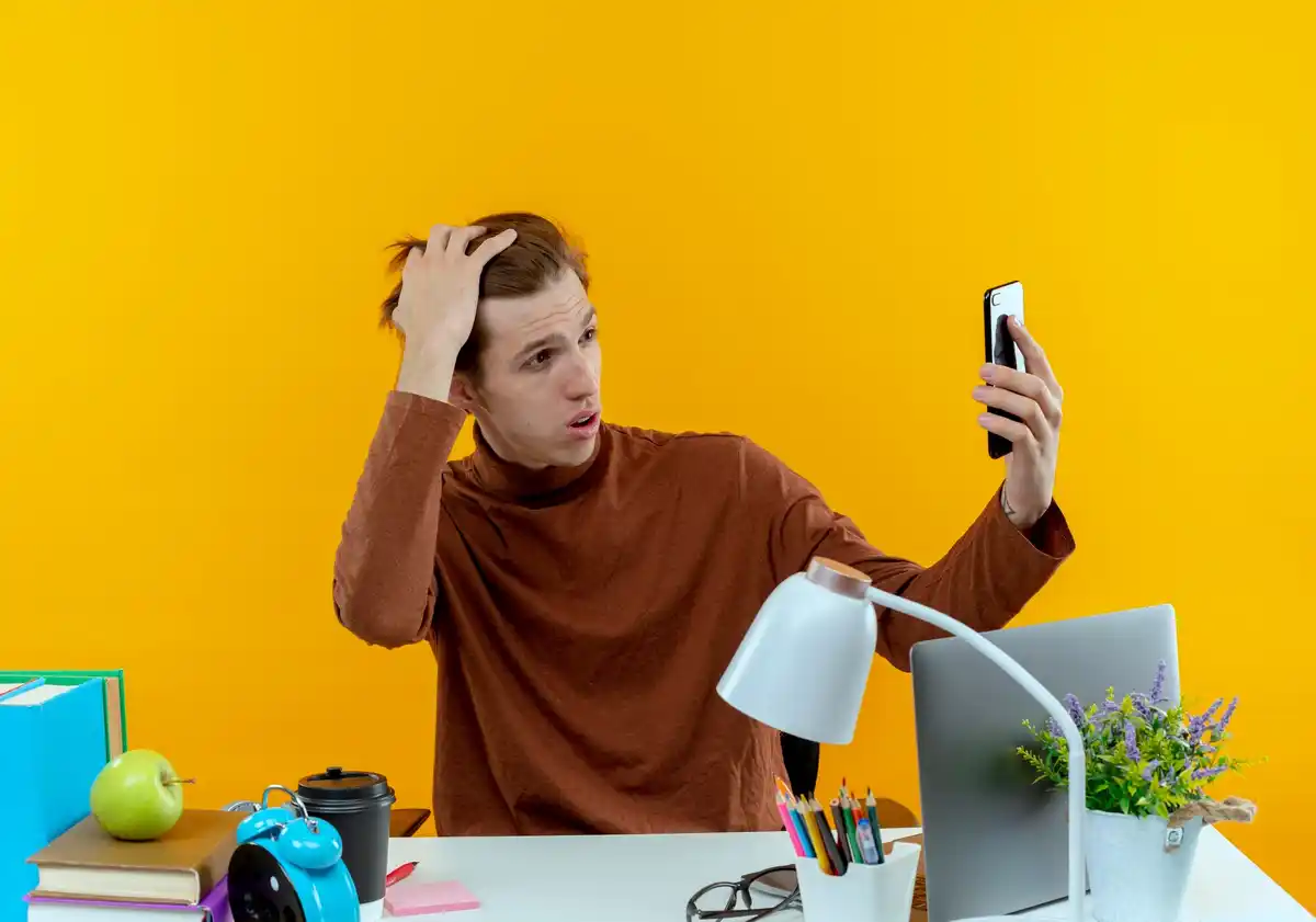 frustrated person with smartphone troubleshooting gadgets