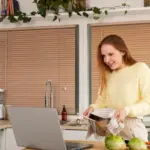 focused person using kitchen timer at desk