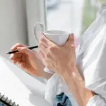 focused person working with planner and coffee