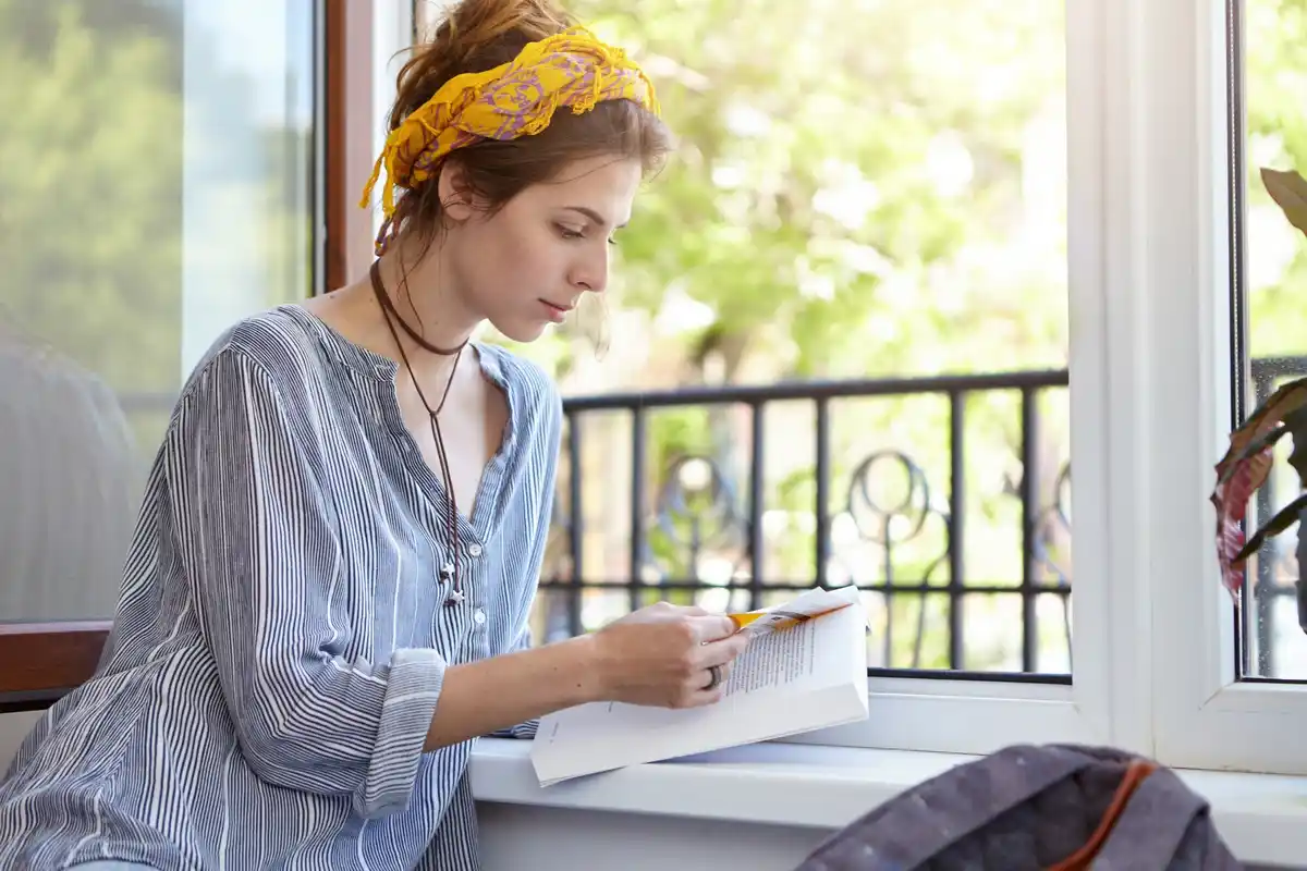 Cleaning windows with newspaper in Dutch home