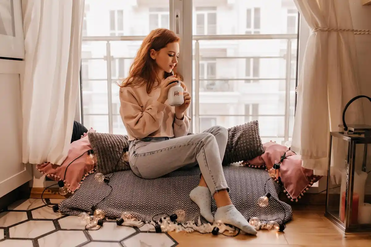woman relaxing with eyes closed in a cozy living room