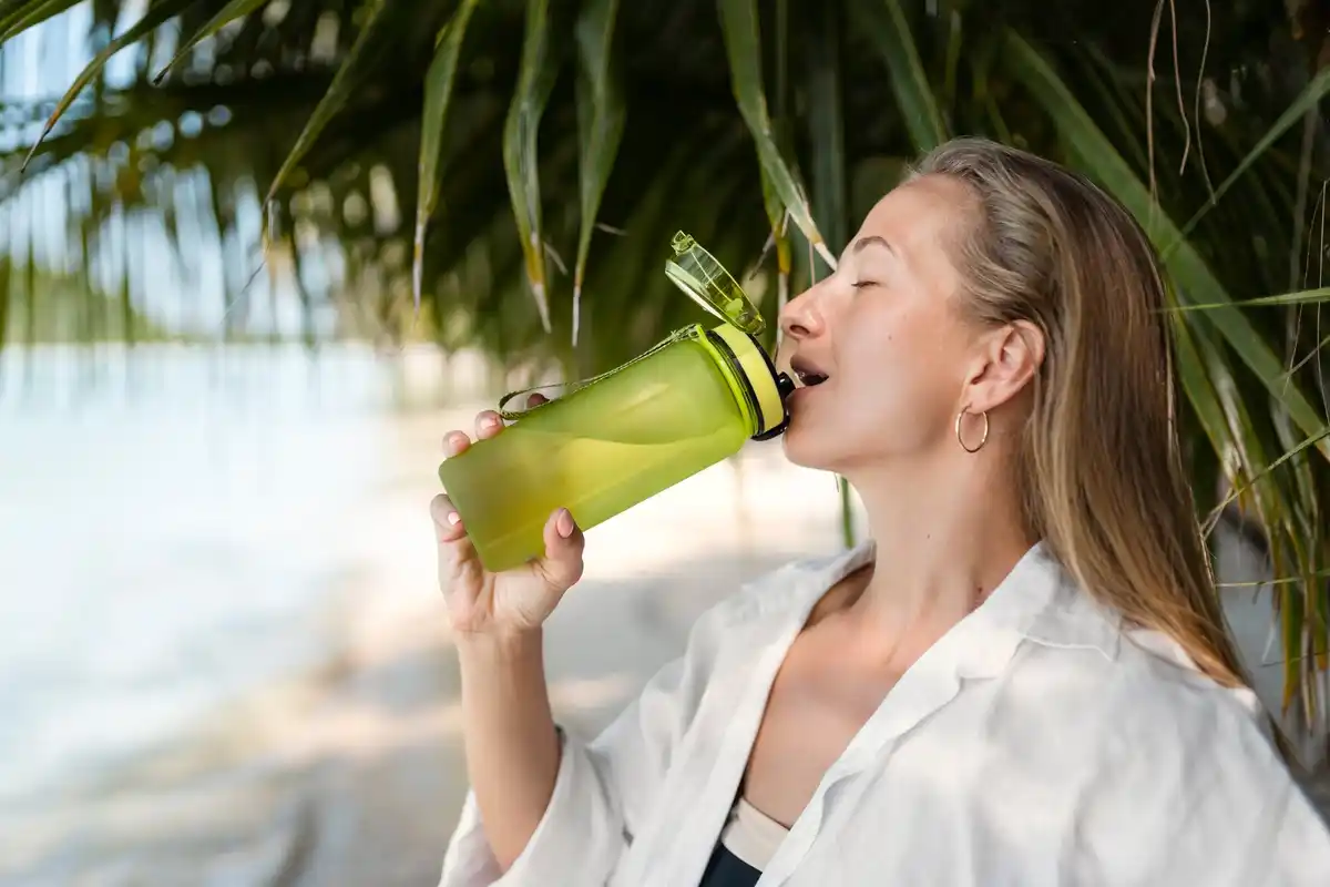 person drinking coconut water natural hydration outdoors