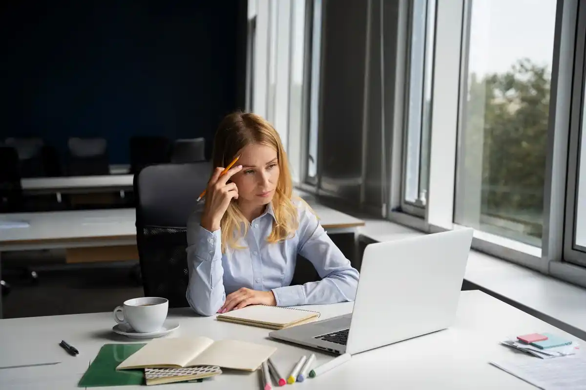 person struggling with multitasking office environment