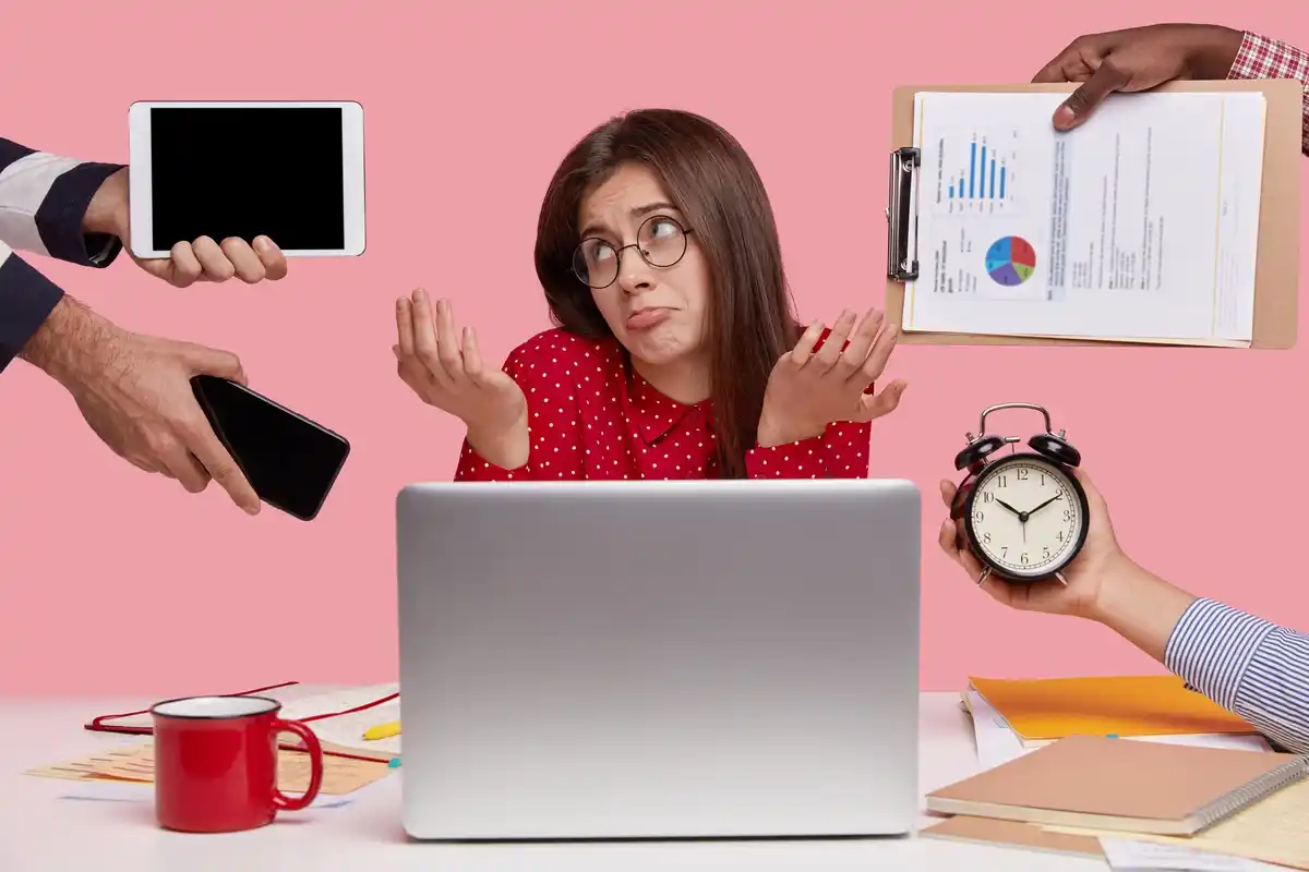 person overwhelmed with multiple devices
