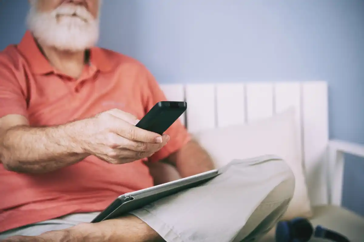 elderly person guided to restart smartphone step by step