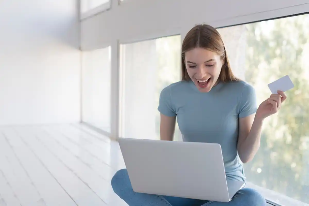 person shopping online with coupon extension on laptop