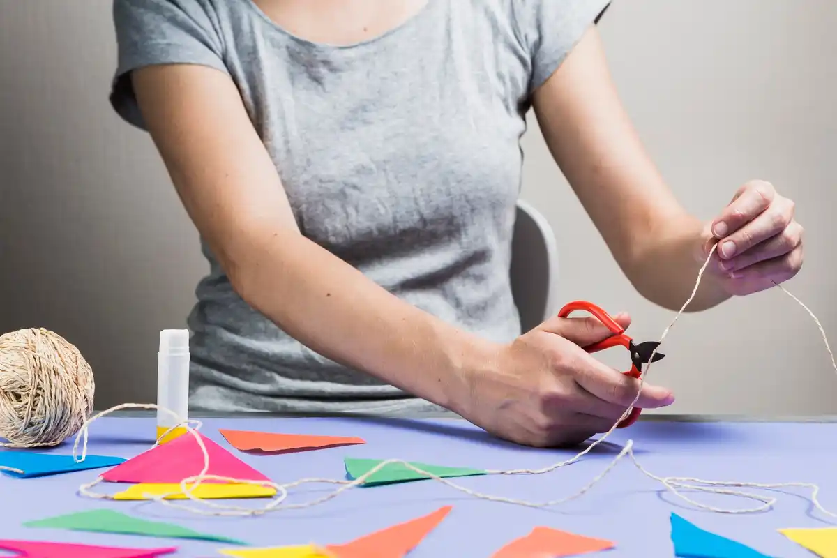 relaxed creative woman crafting at home colorful handmade materials