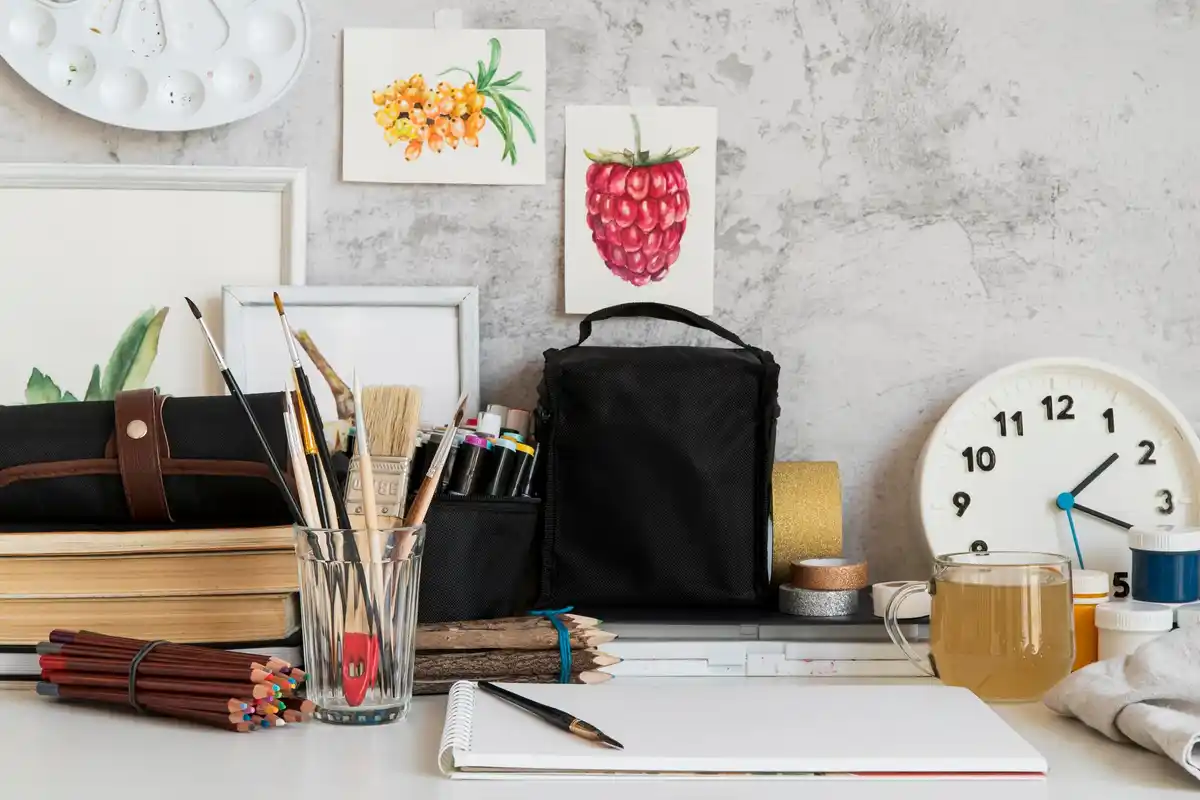 creative workspace with art supplies and laptop