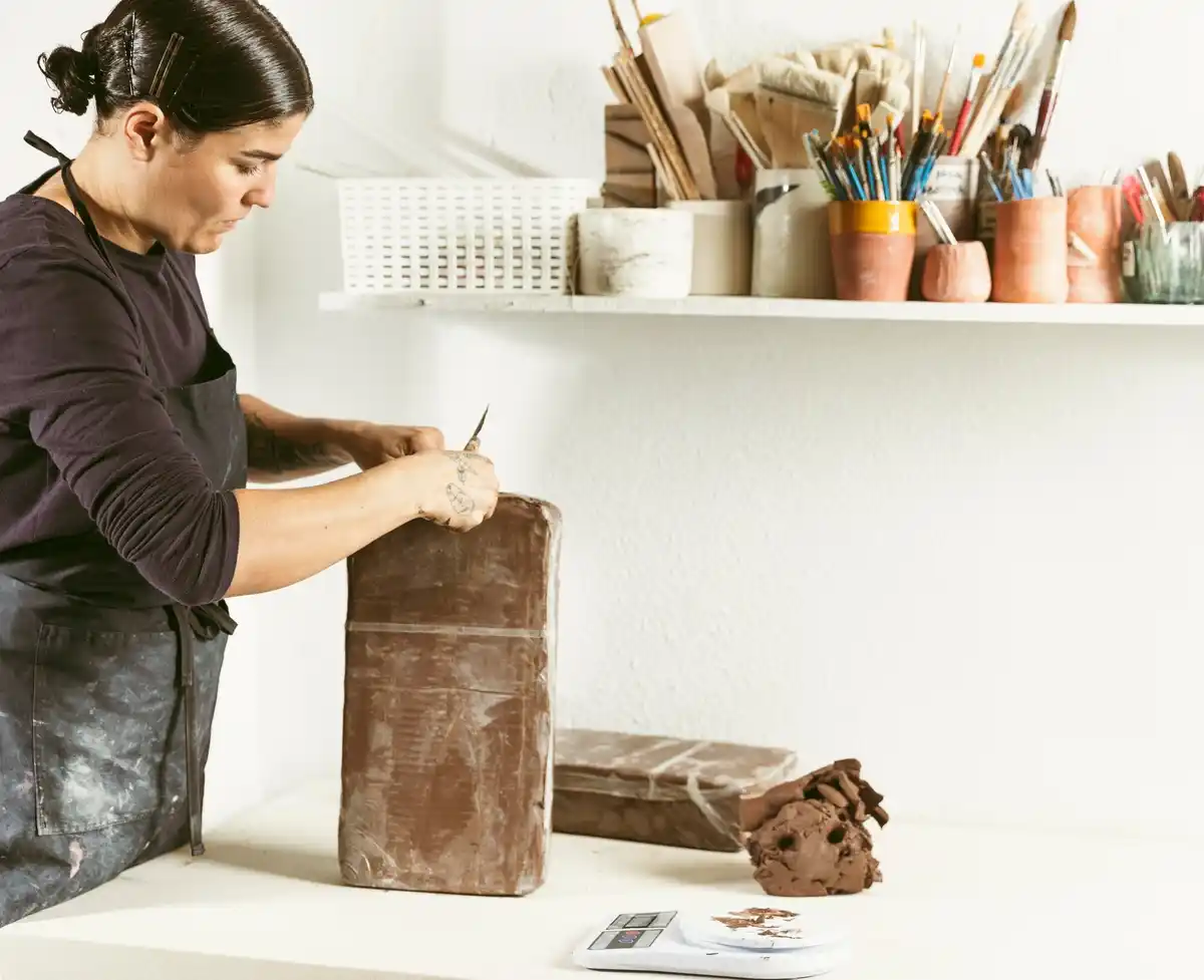 Person crafting wooden art project at home desk