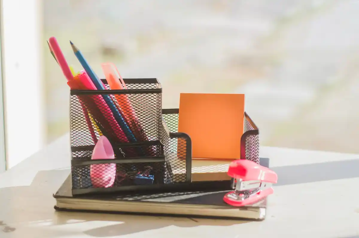 organized desk with storage baskets and labels